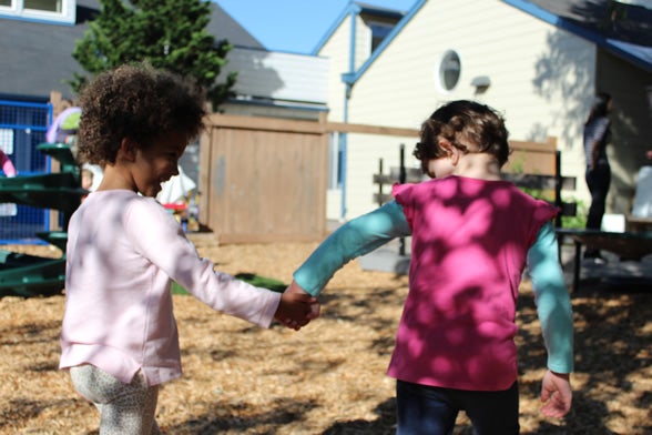 Preschool children holding hands