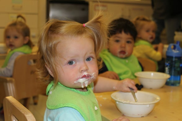 Young child eating yogurt