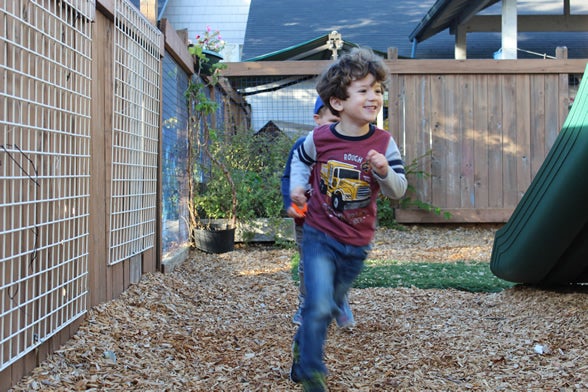 PreK child running on playground