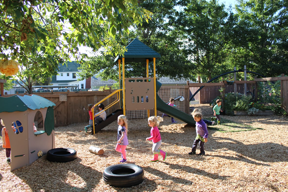 Preschool age children playing on playground